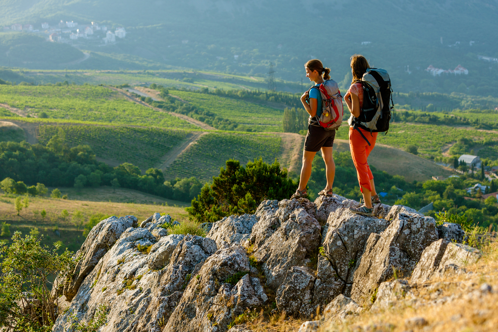 two women hiking and looking out over landscape