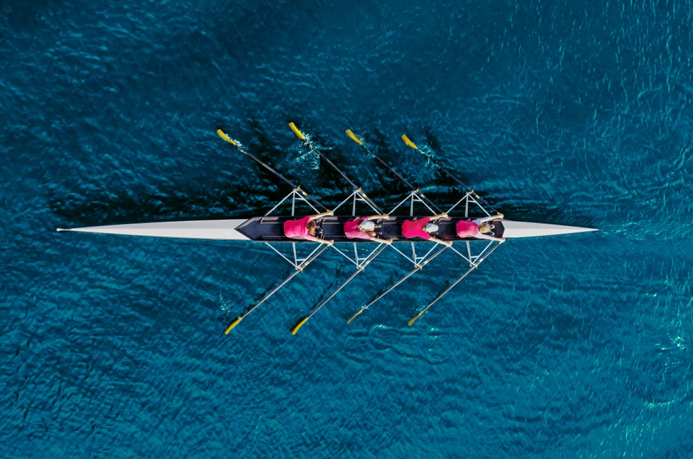people rowing together